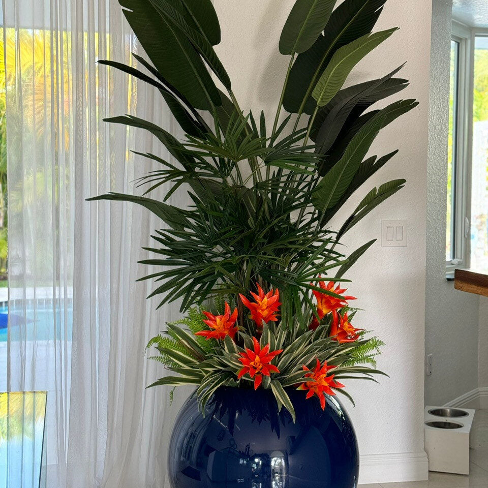 Tropical Palms & Bird of Paradise Arrangement with Red Bromeliads in Navy Globe Vessel